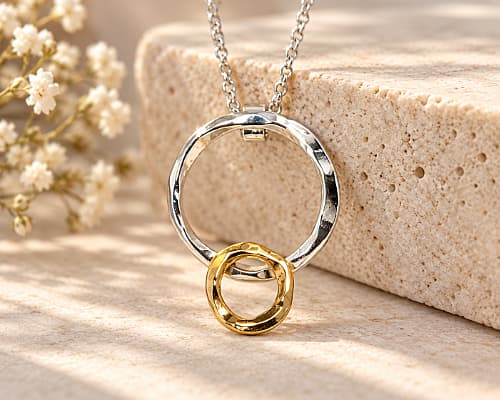 Gold and silver textured necklace consisting of two perfectly imperfect circles