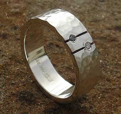 Silver wedding ring with a black and a white diamond