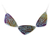 Titanium plectrum pendant featuring layered anodised colours