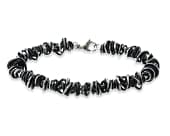 Titanium bracelet featuring a mix of grey and black coiled rings