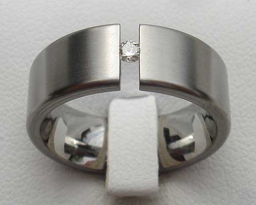Flat tension set titanium engagement ring