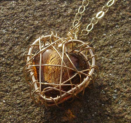 Gold heart cage necklace