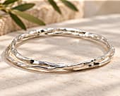 Double bangle combining two contrasting silver bangles into one piece