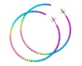 Rainbow titanium hoop earrings featuring beautifully twisted wire that reflects the light