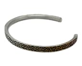 Slim titanium cuff bracelet with a leopard print design
