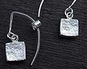 Silver hook earrings in the shape of a key with a heart shape
