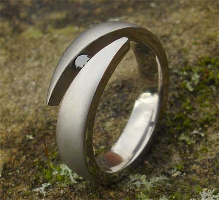 Black diamond tension set titanium engagement ring
